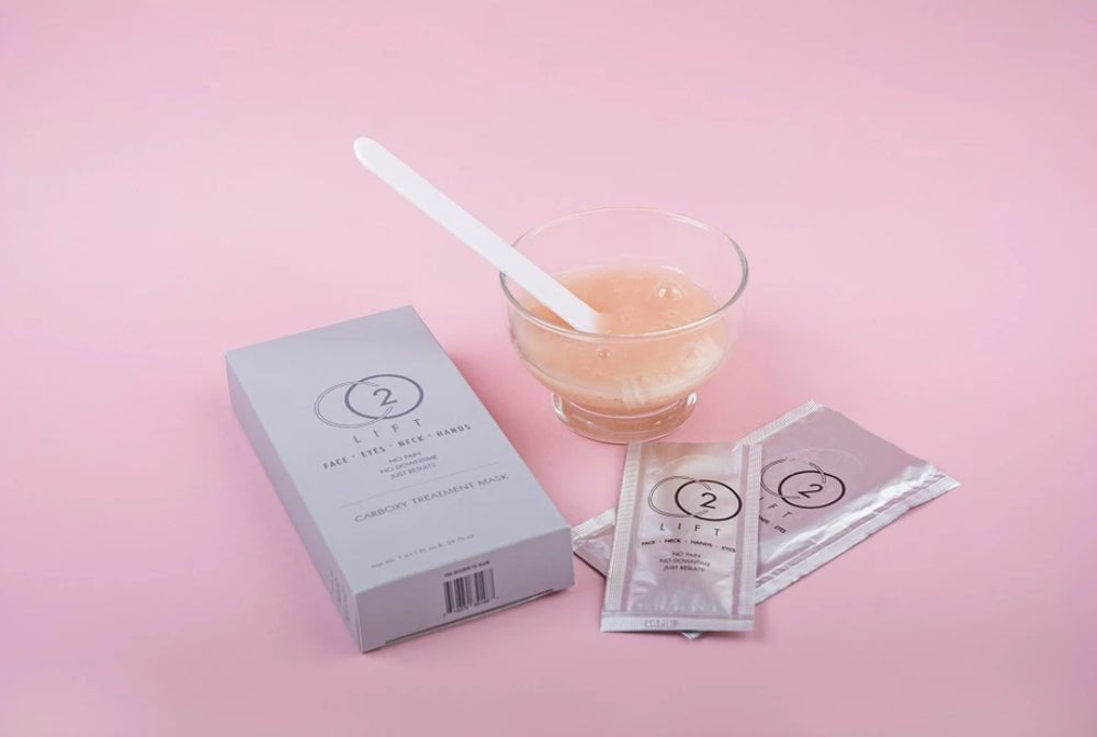 A packaged CO2 Pro Lift gel mask treatment, with contents visible in a small bowl and application sticks